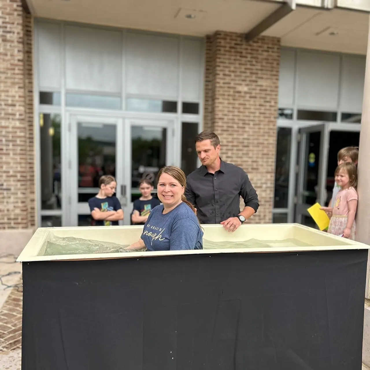 A member of The Bridge Church congregation celebrates during a baptism service.
