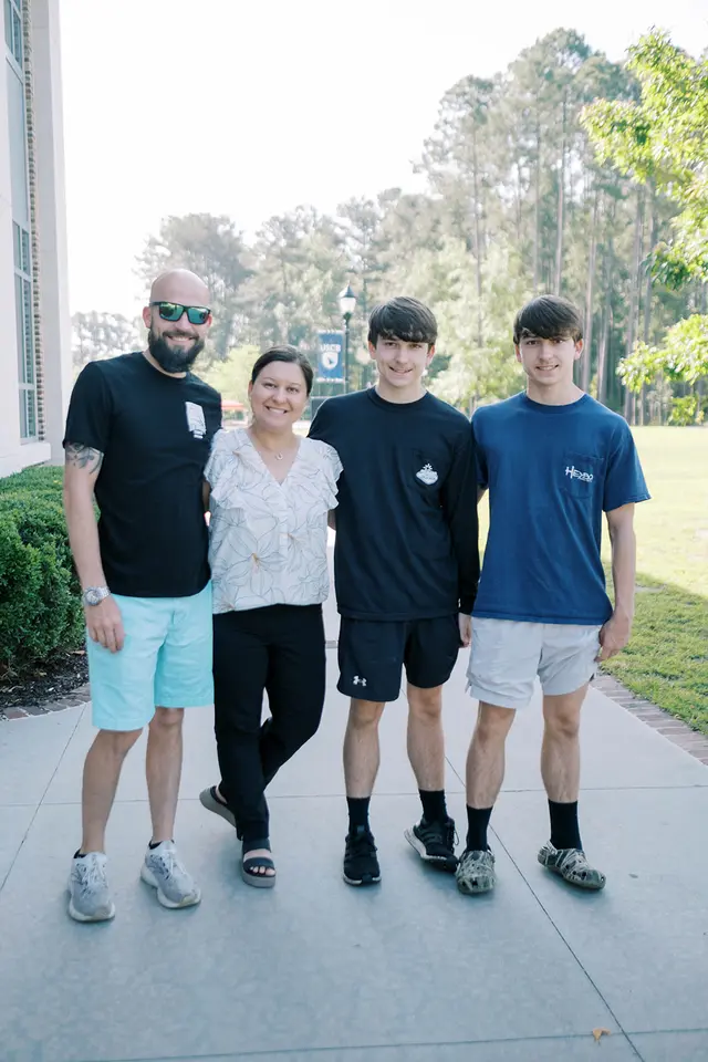 A family of four standing together outside The Bridge Church