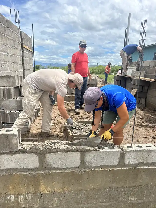 Team members laying concrete block walls on the church addition in Comayagua, Honduras