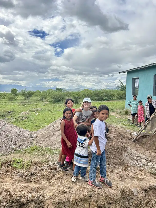 Children from the community in Honduras standing together on a hillside